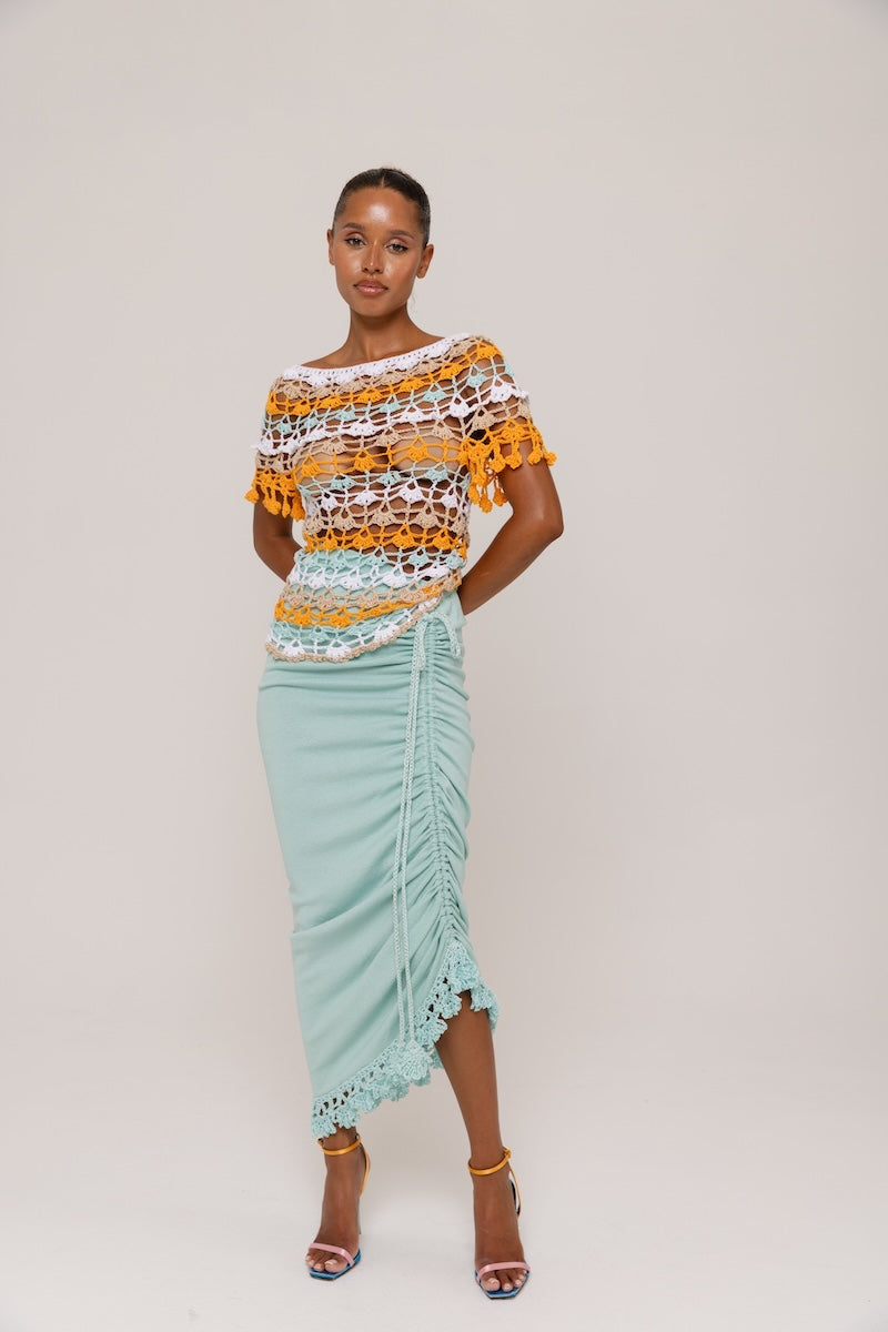 Mint Carnation knit midi skirt by Andreeva with handmade embroidery, featuring a fitted waist and flowing silhouette.