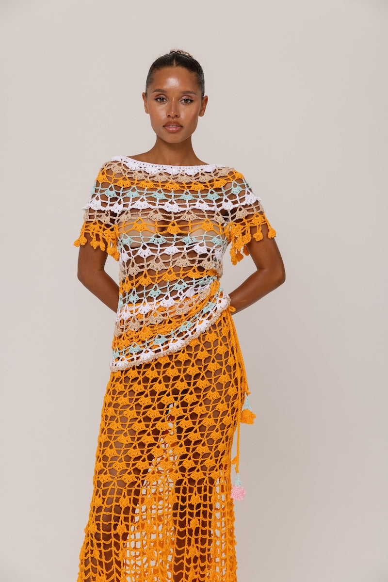 Handmade crochet top by Andreeva featuring vibrant orange and blue colors, showcasing intricate crochet patterns and a stylish fit.
