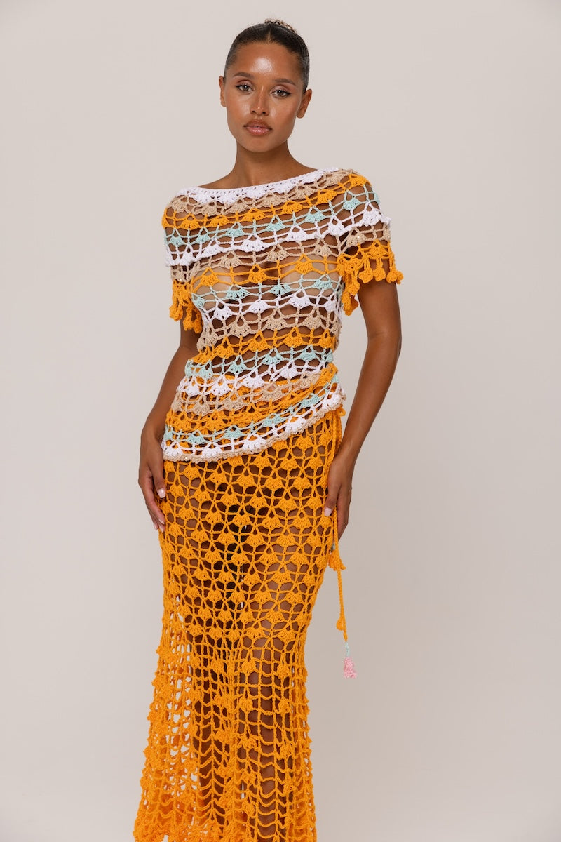 Handmade crochet top from Andreeva featuring vibrant orange and blue bird of paradise design on a stylish casual top.