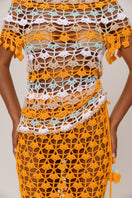 Handmade crochet top by Andreeva in vibrant orange and blue, featuring intricate crochet patterns and a stylish fit.