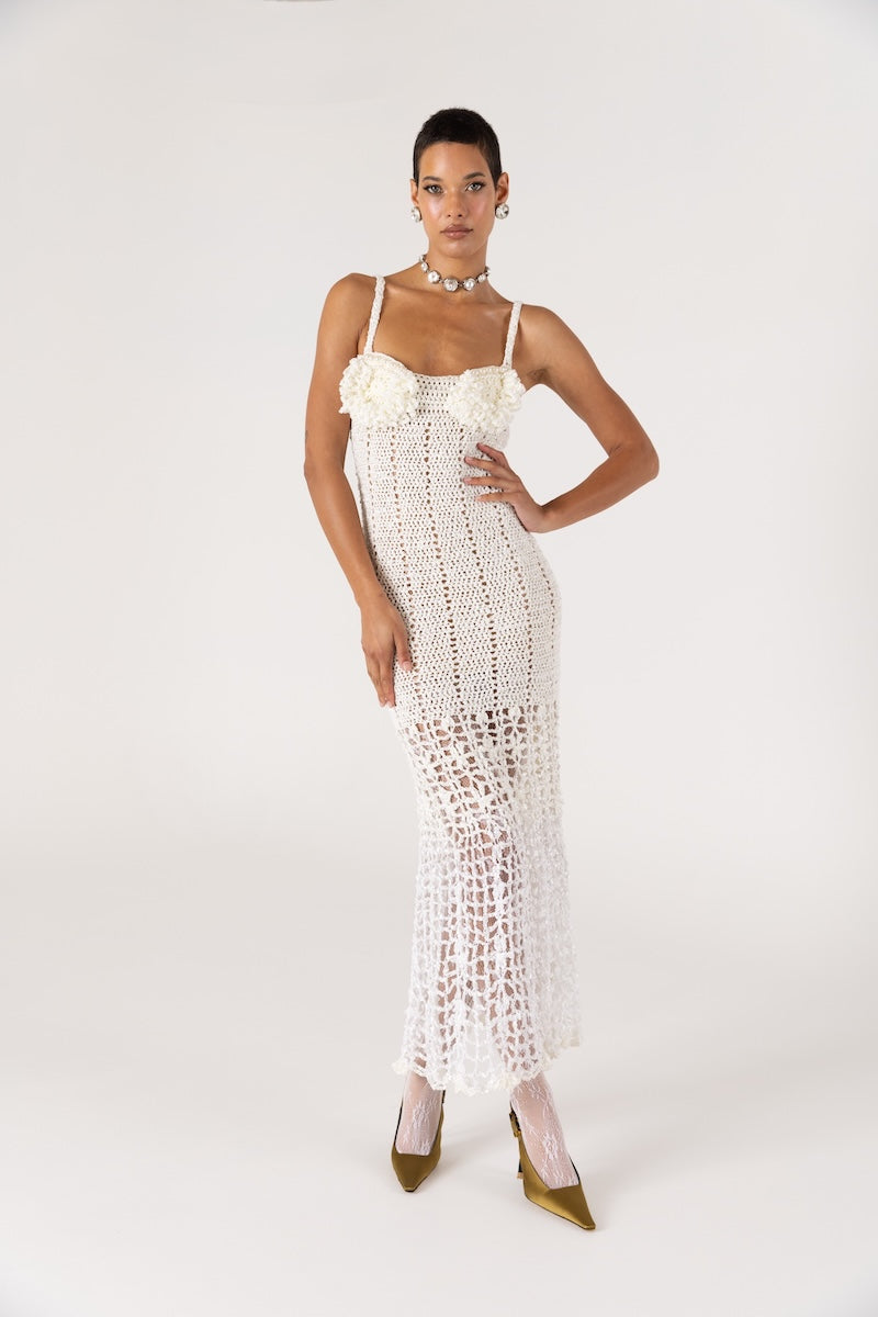 White handmade crochet chrysanthemum maxi dress by Andreeva with intricate floral patterns, flowing fabric, and elegant design.