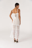White handmade crochet chrysanthemum maxi dress by Andreeva featuring intricate crochet patterns and flowing fabric.