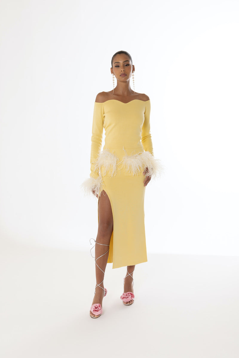 Yellow vanilla knit midi skirt with feather details from Andreeva, featuring a soft, cozy fabric and stylish feather accents.