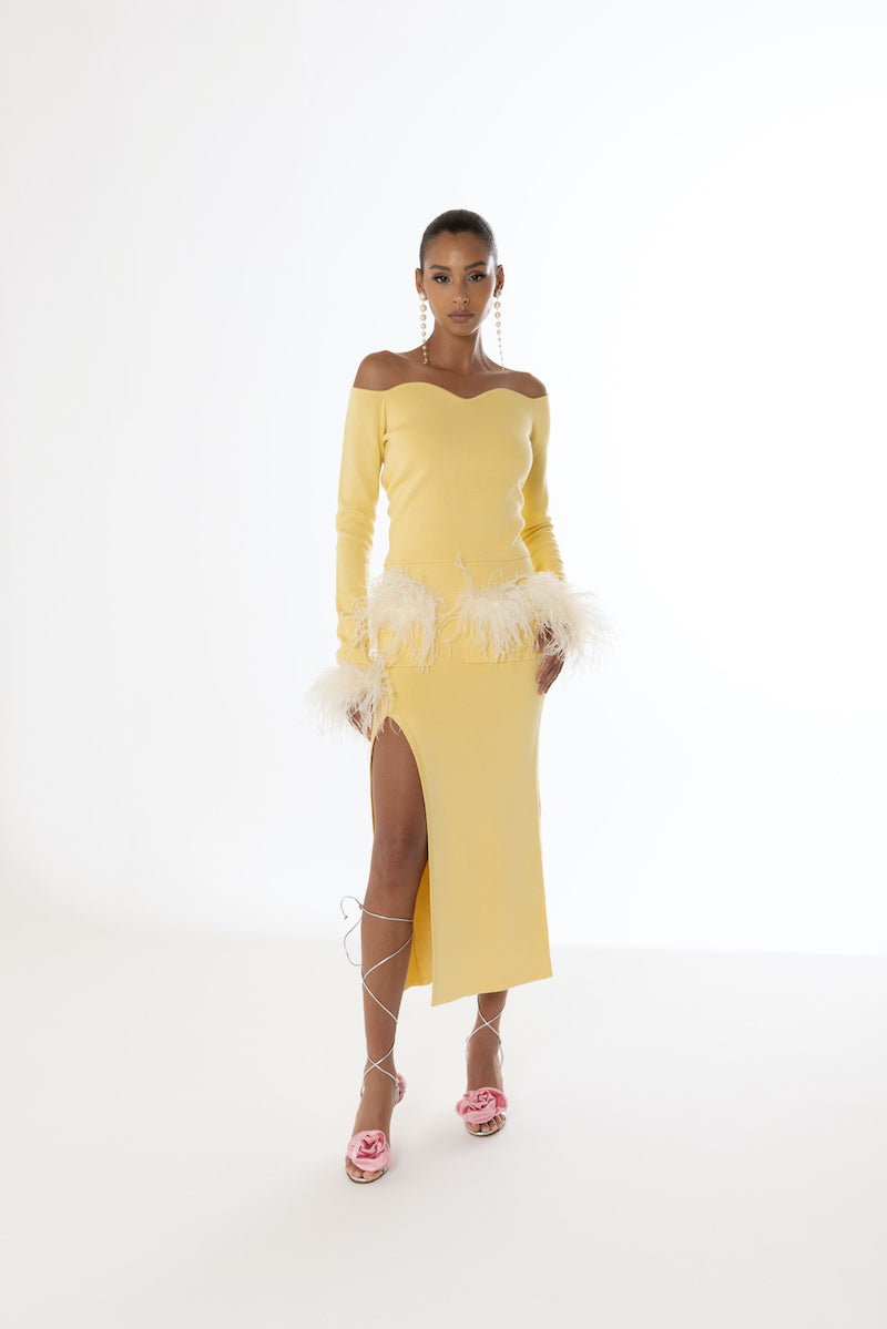 Yellow vanilla knit top with detachable feather cuffs by Andreeva, featuring a cozy fit and stylish feather detail.