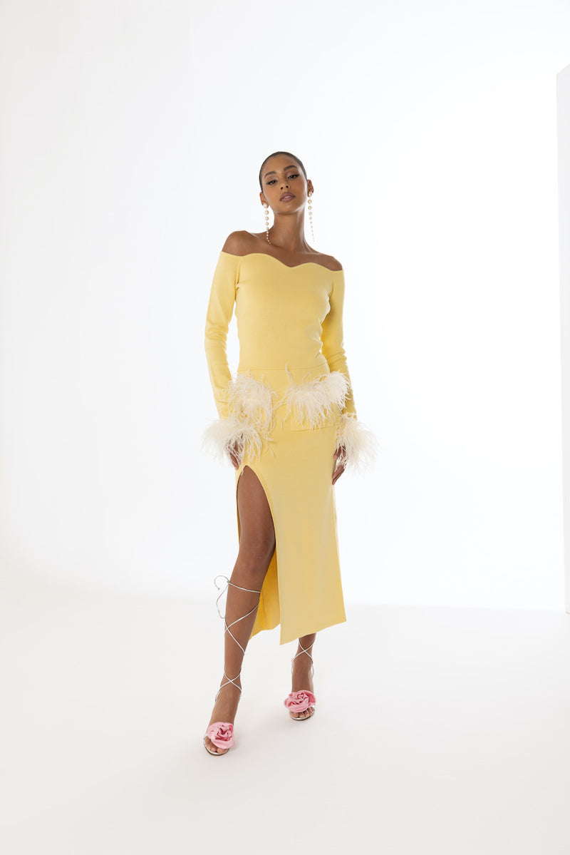 Yellow vanilla knit midi skirt with feather details from Andreeva, featuring a soft, textured fabric and stylish design.