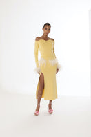 Yellow vanilla knit midi skirt with feather details by Andreeva, featuring a soft knit fabric and elegant feather accents.