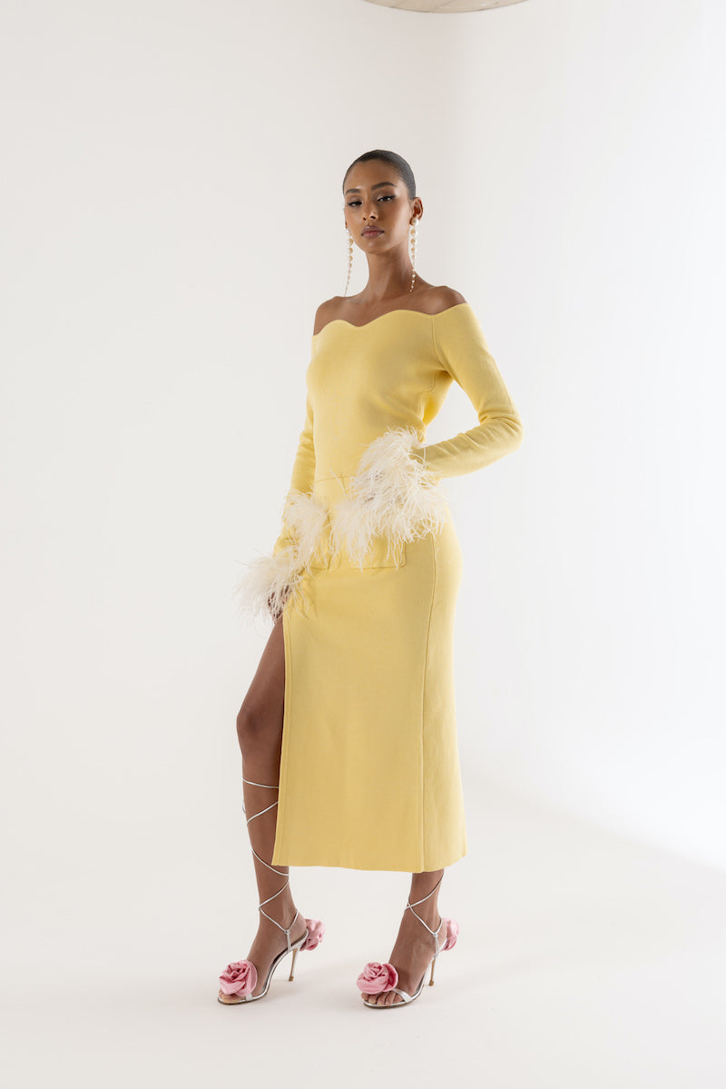 Yellow vanilla knit top with detachable feather cuffs by Andreeva, showcasing a stylish, cozy design with unique feather details.