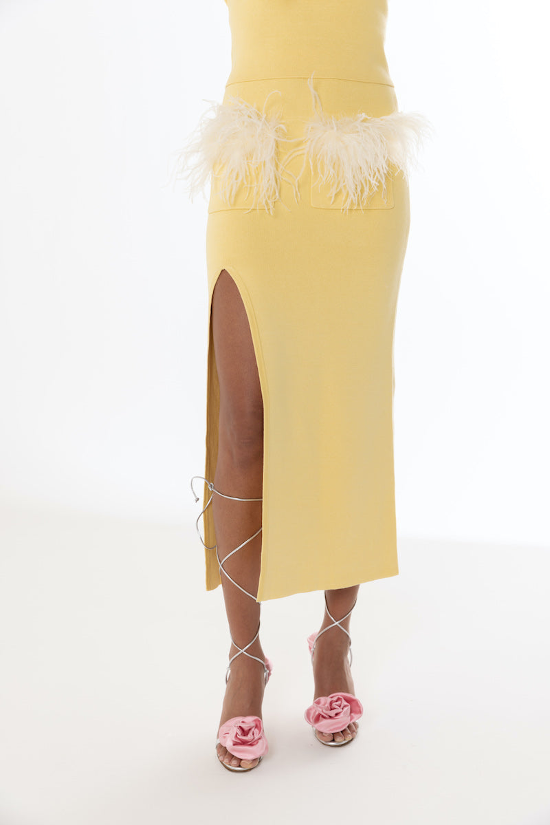 Yellow vanilla knit midi skirt with feather details by Andreeva, shown on a model.
