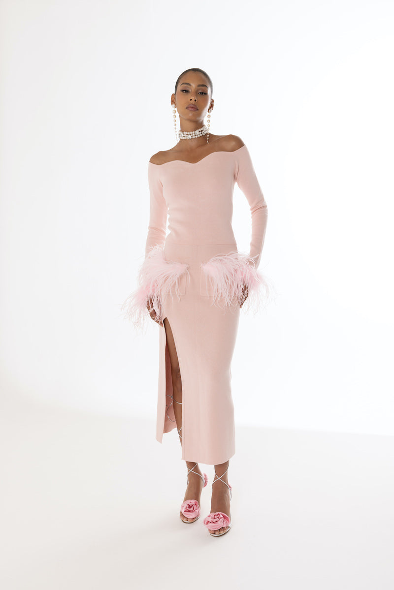 Pink vanilla knit midi skirt with feather accents from Andreeva, featuring soft fabric and stylish, elegant design.