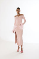 Pink vanilla knit midi skirt with feather accents by Andreeva, shown on a model with a flowy, stylish design.