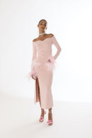 Pink vanilla knit midi skirt with feather details from Andreeva, shown hanging on a wooden hanger.
