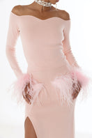 Pink vanilla knit midi skirt with feather accents by Andreeva, shown on a model with a flowing, stylish design.