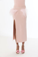 Pink vanilla knit midi skirt with feather details by Andreeva, shown with a soft, textured fabric and elegant design.