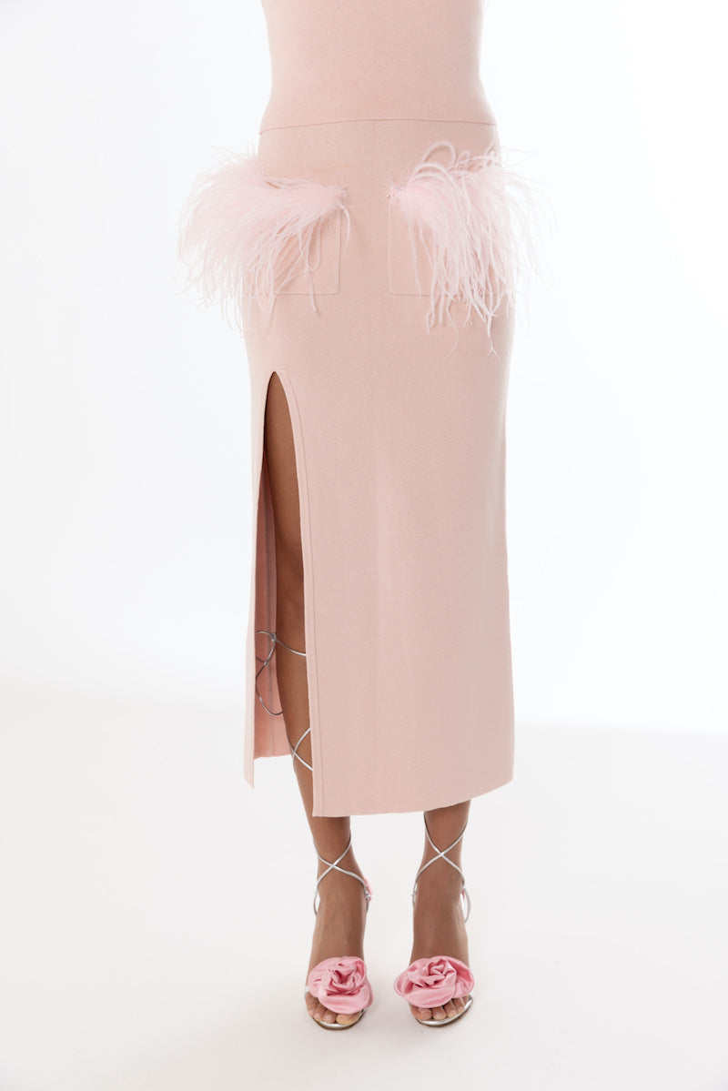 Pink vanilla knit midi skirt with feather details by Andreeva, shown with a soft, textured fabric and elegant design.