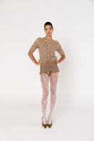 Brown handmade crochet shorts by Andreeva with intricate detailing, styled casually on a model.