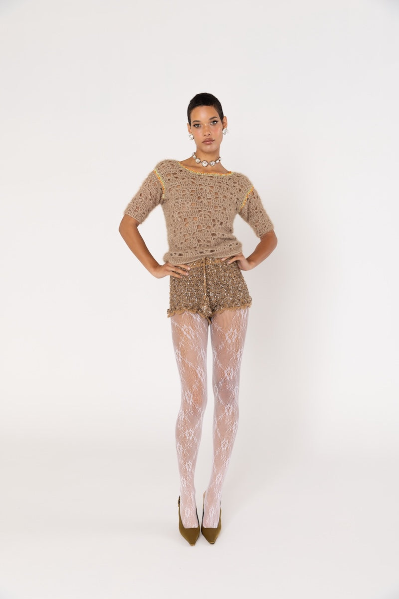 Brown handmade crochet shorts by Andreeva with intricate detailing, styled casually on a model.