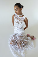 White vanilla handmade maxi crochet dress by Andreeva displayed on a model, featuring intricate crochet details and flowing fabric.