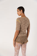 Brown handmade crochet shorts with intricate detailing, designed by Andreeva, showcased on a neutral background.