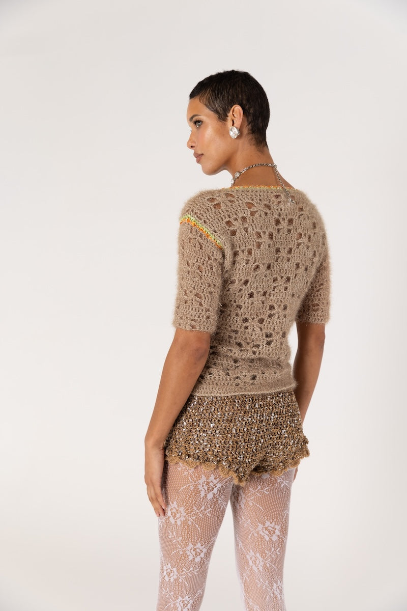 Brown handmade crochet shorts with intricate detailing, designed by Andreeva, showcased on a neutral background.