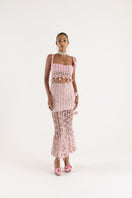 Pink vanilla handmade knit midi skirt from Andreeva, featuring a soft, textured fabric and a stylish, flowy silhouette.