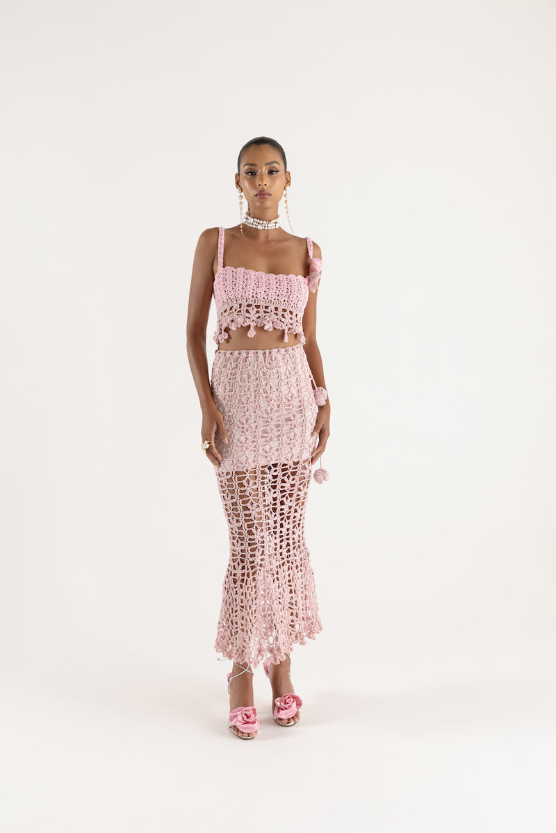 Pink vanilla handmade knit midi skirt from Andreeva, featuring a soft, textured fabric and a stylish, flowy silhouette.