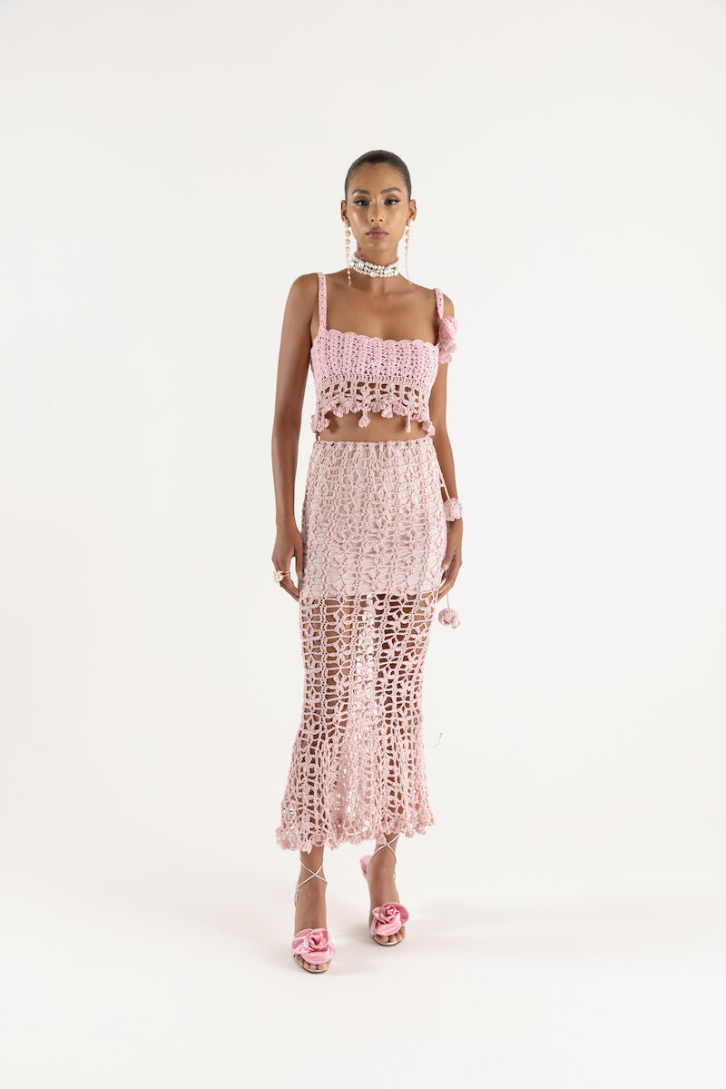 Pink vanilla handmade knit midi skirt by Andreeva, featuring a soft textured fabric and stylish midi length.