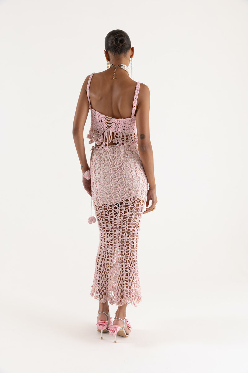 Pink vanilla handmade knit midi skirt by Andreeva, showcasing soft fabric and stylish design on a neutral background.