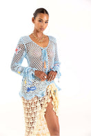 Yellow handmade crochet cover-up by Andreeva, showcasing intricate crochet patterns and a relaxed, bohemian style.