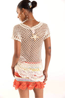Handmade coral reef crochet mini skirt by Andreeva, showcasing intricate pattern and vibrant coral color.