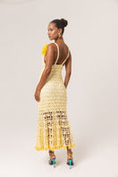 Yellow crochet midi dress by Andreeva featuring intricate handmade floral patterns and a flowing silhouette.