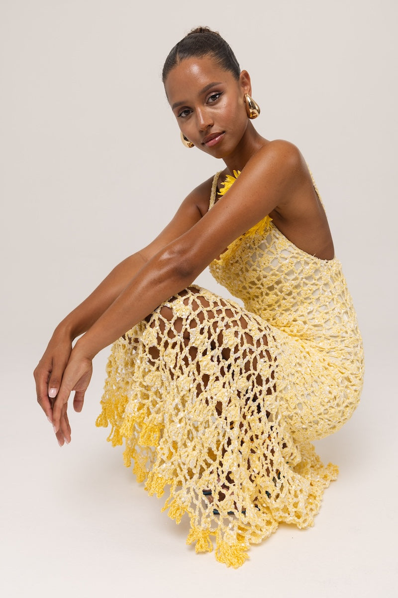 Yellow crochet midi dress by Andreeva featuring intricate handmade floral details, perfect for elegant occasions.