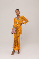 Orange handmade knit midi skirt by Andreeva featuring a California poppy pattern, styled for a casual or bohemian look.