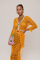 Orange California poppy handmade knit midi skirt by Andreeva featuring a flowy, textured design and a comfortable waistband.