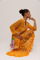 Orange handmade crochet shirt featuring California poppy design by Andreeva, styled with long sleeves and intricate crochet patterns.