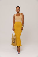 Golden Hour metallic knit maxi dress by Andreeva, featuring a shimmering gold finish and fitted silhouette.