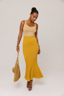 Golden Hour metallic knit maxi dress by Andreeva, featuring a shiny gold finish and a flowing, elegant silhouette.