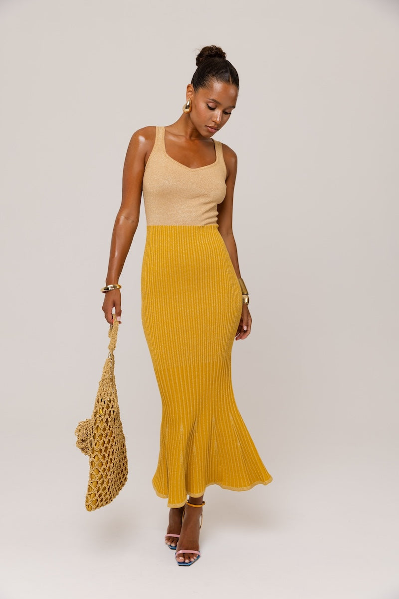 Golden Hour metallic knit maxi dress by Andreeva, featuring a shiny gold finish and a flowing, elegant silhouette.