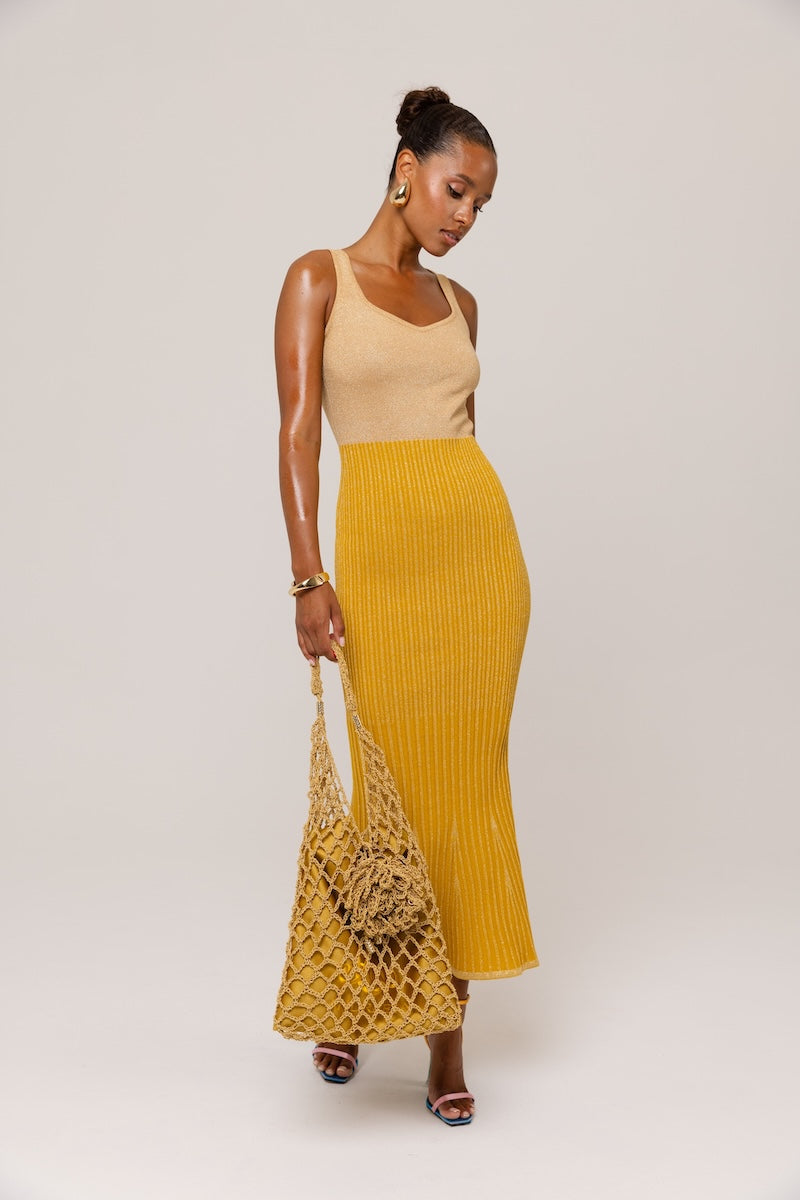 Golden Hour metallic knit maxi dress by Andreeva featuring a shimmering gold finish and elegant, flowing silhouette.