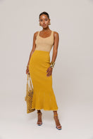 Golden Hour metallic knit maxi dress by Andreeva, featuring a shimmering gold finish and elegant, flowing design.