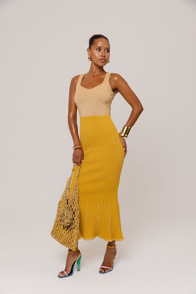 Golden Hour metallic knit maxi dress by Andreeva featuring a shimmering gold finish and a flowing, elegant silhouette.