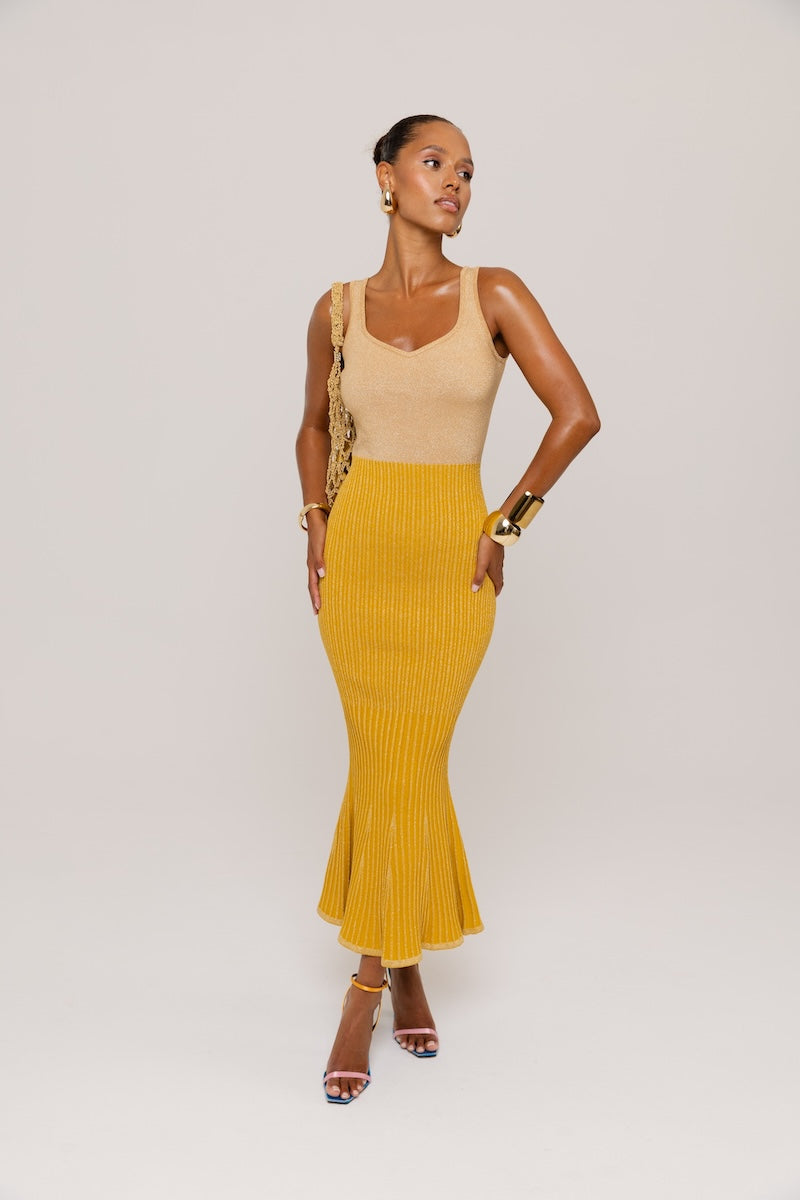 Golden Hour metallic knit maxi dress by Andreeva featuring a shimmering gold finish and a flowing, elegant silhouette.