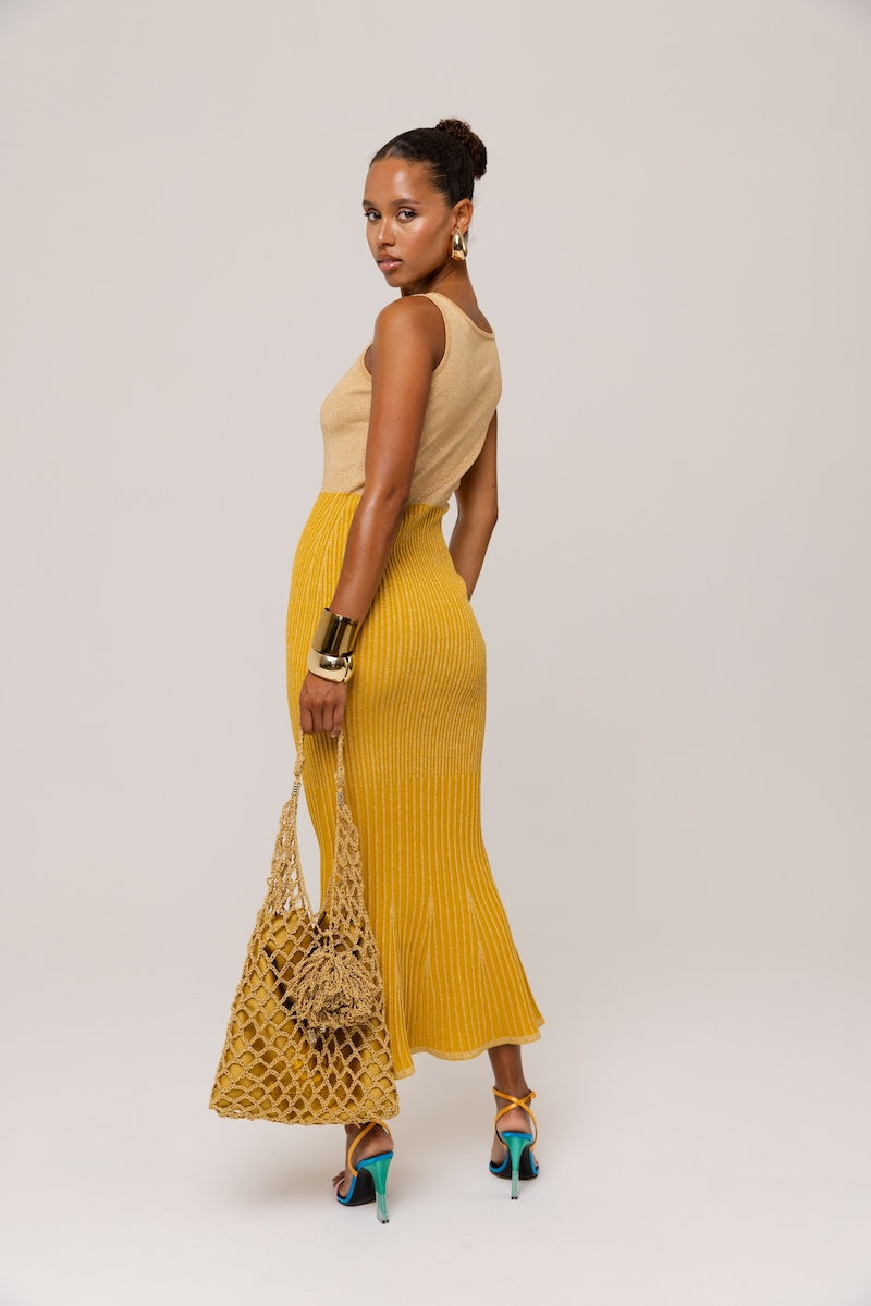 Golden Hour metallic knit maxi dress by Andreeva, featuring a shimmering gold finish and elegant, flowing silhouette.