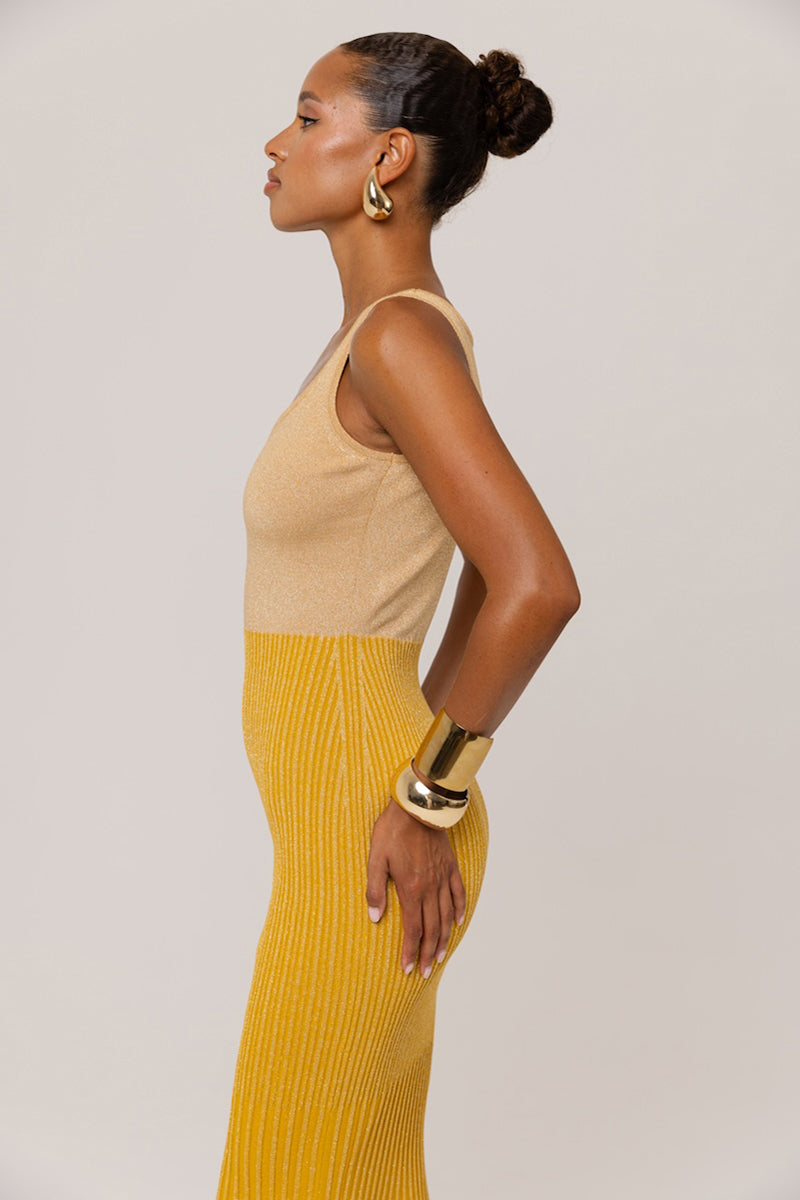 Golden Hour metallic knit maxi dress by Andreeva, featuring a shimmering gold finish and a flowing, elegant silhouette.