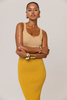 Golden Hour metallic knit maxi dress by Andreeva featuring a shimmering gold finish and elegant fitted silhouette.