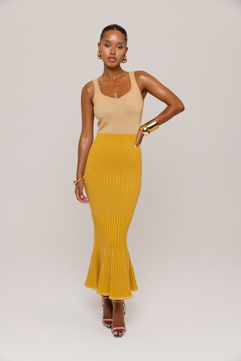 Golden Hour metallic knit maxi dress by Andreeva featuring a shimmering gold finish and a flowing, elegant silhouette.