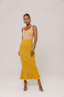 Golden Hour metallic knit maxi dress by Andreeva, featuring a shimmering gold finish and elegant, flowing silhouette.
