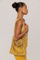 Golden Hour metallic knit maxi dress by Andreeva, featuring a shimmering gold finish and elegant long sleeves.