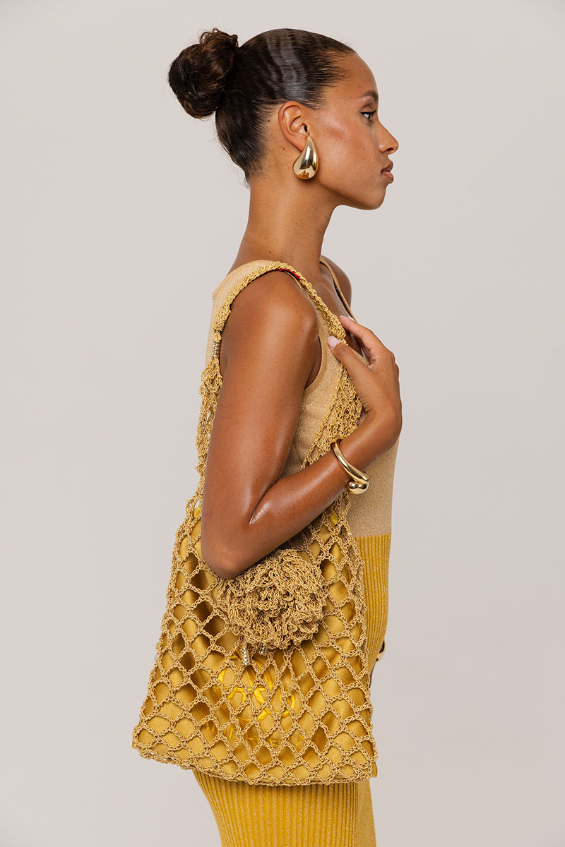Golden Hour metallic knit maxi dress by Andreeva, featuring a shimmering gold finish and elegant long sleeves.