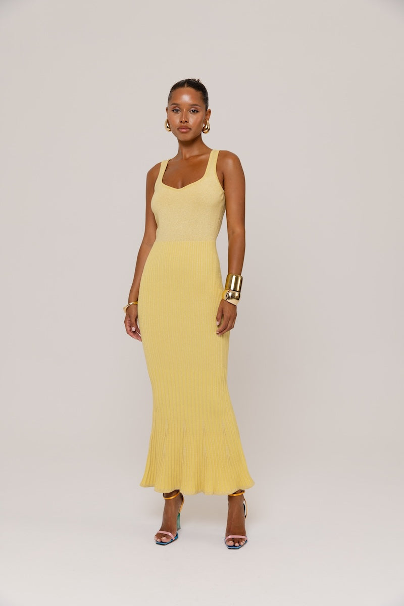 Yellow metallic knit maxi dress by Andreeva, featuring a fitted bodice and flowing skirt, perfect for stylish occasions.