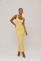 Yellow metallic knit maxi dress by Andreeva, featuring a flowing design and long sleeves, perfect for stylish occasions.